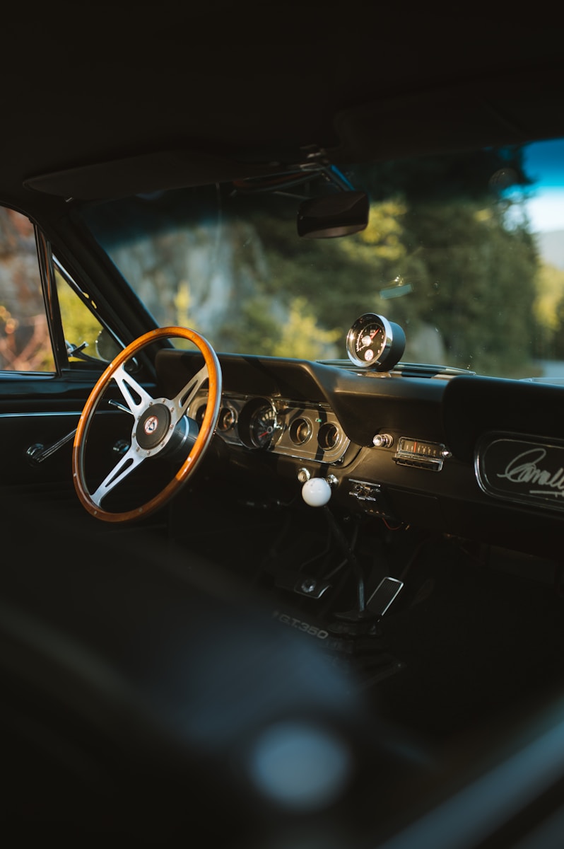 the interior of a car with a steering wheel and dashboard