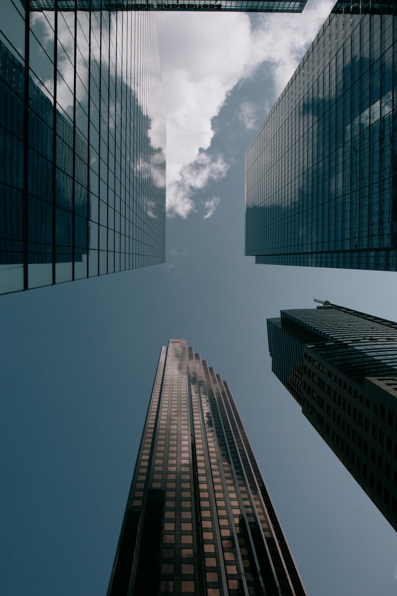 looking up at skyscrapers from the ground