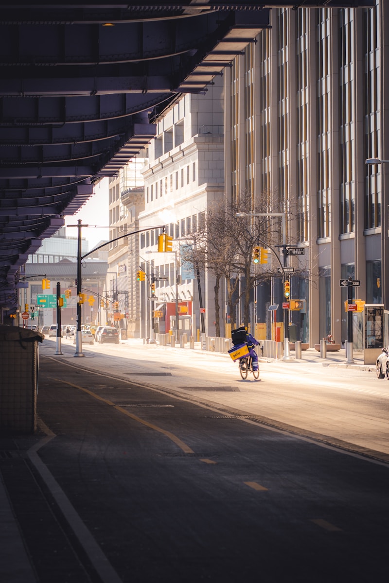 a person riding a bike down a city street
