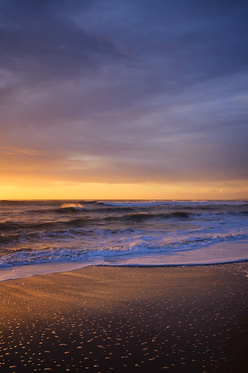 a beach with waves coming in to shore